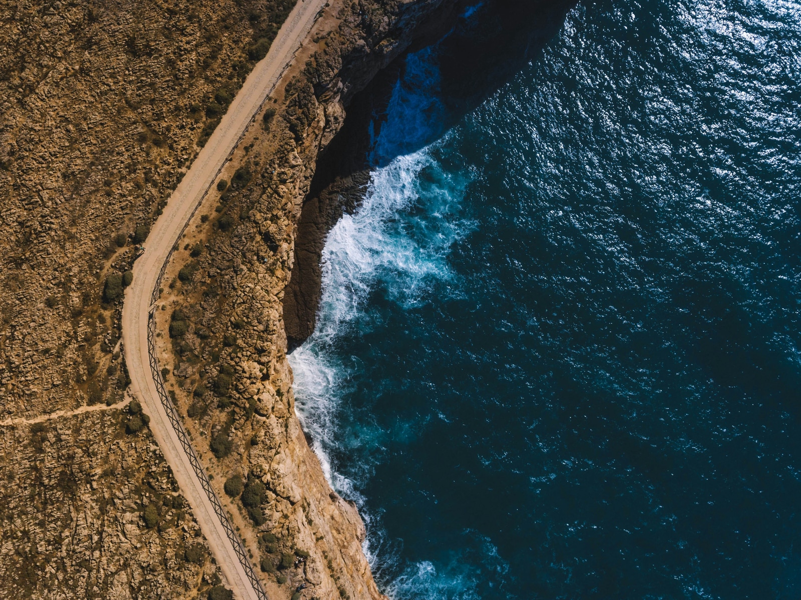 A quiet path following the edge of a rugged coastline