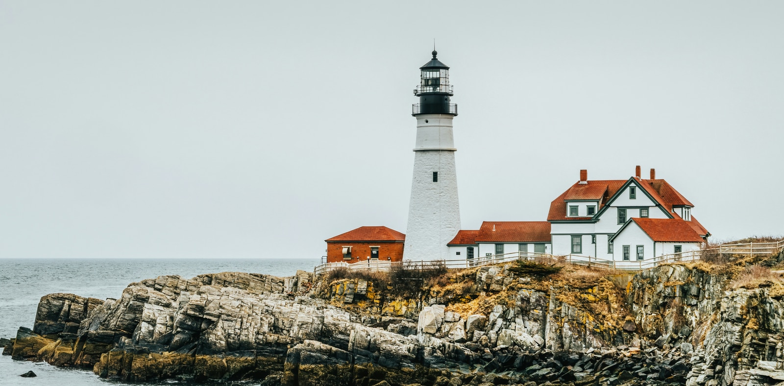 A white lighthouse overlooking the rugged Atlantic coastline
